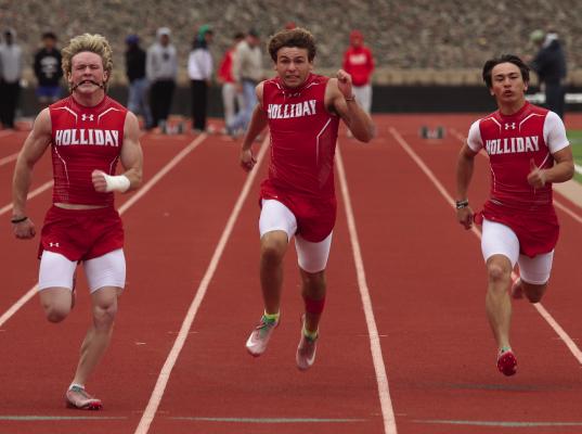 L-R: Tyce Whittington, Canon Faulkner, and Jaedin Kim sprint through the finish in the 100 meter dash at the district meet in Iowa Park. Photo/Landon Davis