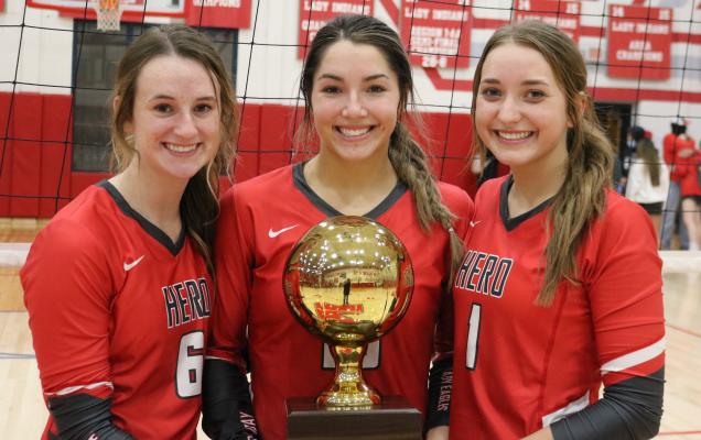 Seniors Avery Stone, Bree Zellers and Brittany James pose for a shot with the regional semifinal championship trophy following Holliday’s 3-0 win over Brownfield on Tuesday, Nov. 10, in Tuscola.
