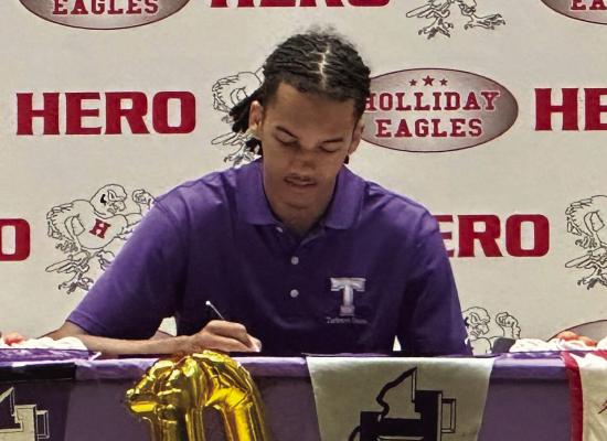 Holliday Forward Keitenn Bristow signs his national letter of intent to play basketball at Tarleton State University in a signing ceremony Tuesday, May 14. Photo/Landon Davis