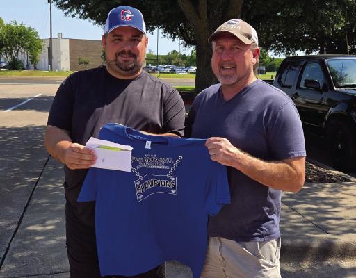 Ruby McCaskill Memorial Softball Tournament organizer Jeffrey Blassingame Jr. presented a shirt and over $2000 of proceeds to Archer City’s Kenneth Stephens Jr. on Saturday, Aug. 9. Photo/Landon Davis