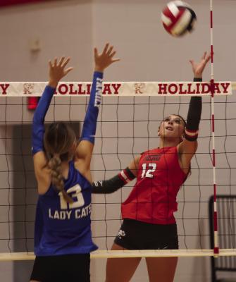 Senior Addisyn Scott looks for a tip over the Ladycats’ frontline in the Lady Eagles’ home game versus Childress. Photo/Landon Davis