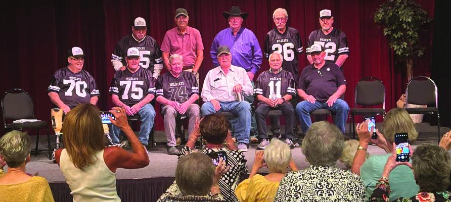 Members of the 1964 State Champion Wildcats team pose for a photo at the 60th reunion of the team's title run at the Royal Theater on Saturday, Oct. 5. The team defeated Ingleside 13-6 to take home the state title for Archer City. Photo/Jerry Phillips