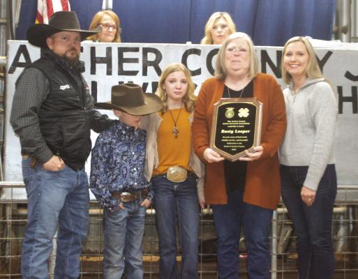 The Looper family accepts the plaque posthumously recognizing Rusty Looper for his years of service on the Archer County Junior Livestock Show board on Saturday, Jan. 7. Photo/Nathan Lawson
