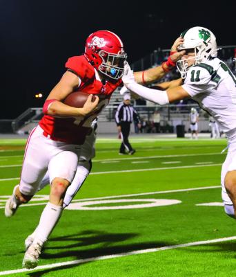 Sophomore running back Brayden Hamill stiff-arms a would-be Blue Ridge defender in the Eagles’ 42-34 Area playoff round victory on Friday, Nov. 22. Photo/Landon Davis