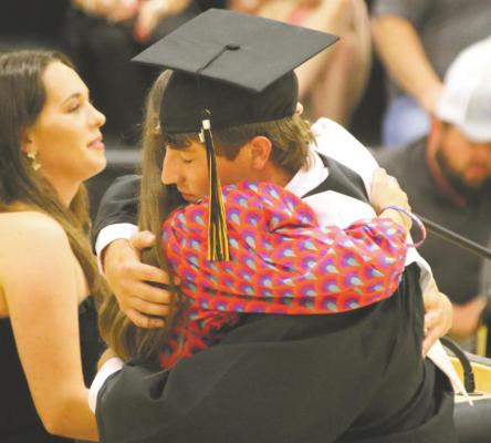 Carter Hilbers embraces Abby Aulds after getting the John Michael Aulds, Jr. Memorial Scholarship. Also pictured is Alex Aulds. Photo/Jerry Phillips