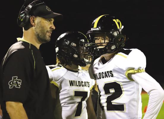 Archer City head coach Bradan Ritchey and quarterback Joe Castles discuss strategy on the sidelines in the Wildcats 35-12 win over Quanah on Friday, Aug. 26. Photo/Jerry Phillips