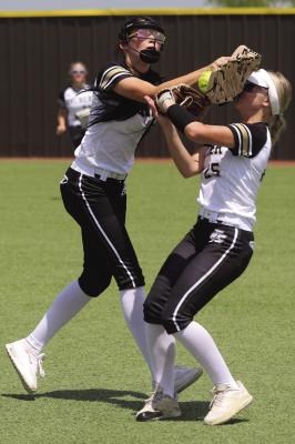 Archer City's Brilee Canada and Ashlyn Harvey cross paths while going for a fly ball during the Lady Cats 13-3 Bi-District win over the Nocona Lady Indians. Photo/Nathan Lawson