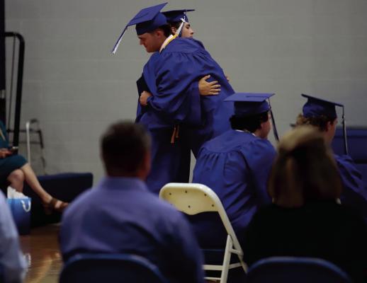 Trojans Cash Armstrong and Brandon Berend hug after receiving their diplomas at the Windthorst Graduation Ceremony on Sunday, May 18. Photo/Landon Davis