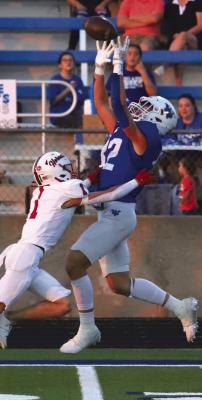 Trojan junior Jaxon Stark makes the leaping, sidelinegrab over a Muenster defender in Windthorst’s 56-21 losss against the Hornets on Friday, Sept. 13. Photo Landon Davis