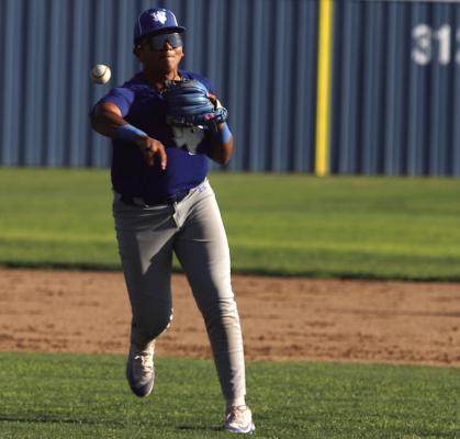 Trojan third baseman Ruben Garcia fields a groundball and shoots a throw to first for the out against Archer City on Tuesday, March 31. Photo/Landon Davis