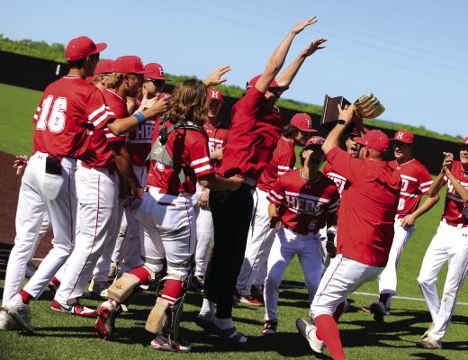 The Holliday Eagles celebrate with the Golden Glove trophy following the Eagles Bi District Round win over Peaster on Saturday, May 3, in Graford. Photo/Nathan Lawson