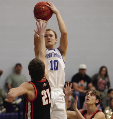 Trojan junior Aiden Stark sinks a midrange jumper over a Nocona defender on Tuesday, Jan. 6. Photo/Landon Davis