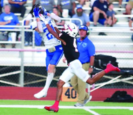 Senior Trojan wideout Daxton Anderson elevates above a Hornet defender for a 32 yard grab on Friday. Photo/Landon Davis