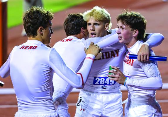Holliday’s Hudson Dray (left), Ty Harrison (middle), and RC Albert (right) surround a bewildered Brayden Hamill (middle) after he helped the Eagles finish second in the 4x400 relay to win the 3A Track and Field State Championships on Thursday, May 14 at Mike A. Myers Stadium. Courtesy photo/Jim Harrison