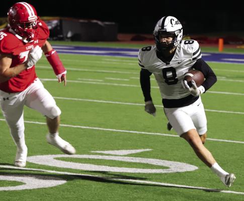 Junior wide receiver Casen Booher looks for room to run after reeling in a pass against the Albany Lions on Thursday, Nov. 21 Photo/Landon Davis
