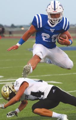 Windthorst junior Clay Hoff hurdles a Clyde defender in the first half of the Trojans’ 52-7 win over the Bulldogs on Friday, Sept. 10. Photo/Will Edwards
