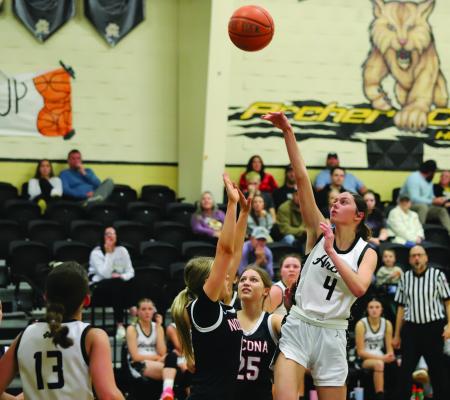 Archer City’s Malia Jones tosses up a floater over a Lady Indian defender in the Lady Cats’ district matchup. Photo/Landon Davis