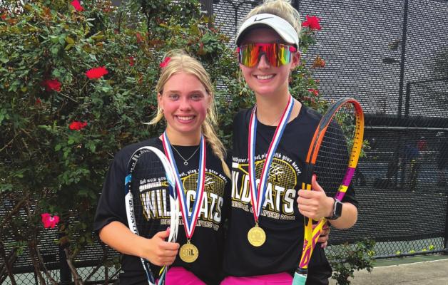 Junior Jill Liles and senior Chandler Clark celebrate with gold medals after dominating the competition at the Region II tennis tournament on Monday and Tuesday. The duo had a bye the first round and never dropped a set in their quest for the title. They will compete at the state tournament in San Antonio on April 26-27. Photo/Jenny Schroeder