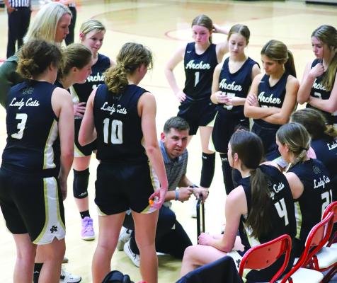 Archer City Head Coach Tyler Owen draws up a play during a timeout in the Lady Cats’ 38-30 loss to Christ Academy on Tuesday, Dec. 20. Photo/Will Edwards