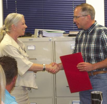 WISD presented with resolution honoring Wolf