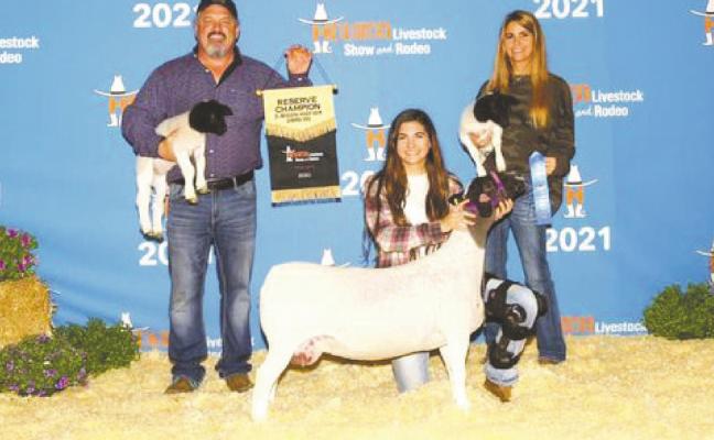 Delaini Hanna (center) poses with her reserve grand champion dorper at the Houston stock show. Also pictured is her father Shad Hanna (left) and mother Becky Hanna (right). Courtesy photo