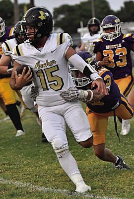Archer City Junior Quarterback Seth Truette powers past a Mogul defender in the Wildcats 62-51 loss to Munday on Friday, Sept. 25. Courtesy photo/Donna Williams