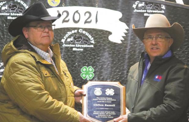 Mike Gilmore (right) presents a plaque to Clifton Russell for his service to the Archer County Junior Livestock Show. Photo/Jerry Phillips