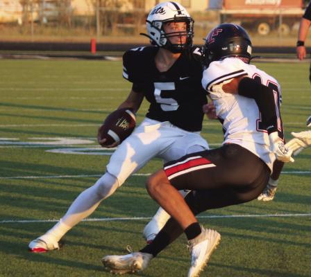 Archer City Quarterback Landon Smith looks for running room in the Wildcats 5028 loss to Anson on Friday, Sept. 6. Photo/Jerry Phillips