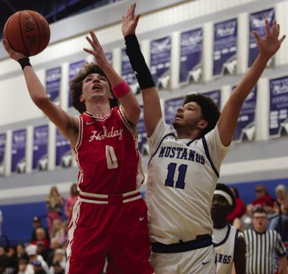 Junior guard Jason Luke fights through contact for a layup in City View on Tuesday. Photo/Landon Davis