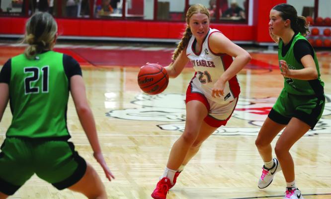 Lady Eagle Jordan Peters drives by an Iowa Park defender in Holliday’s overtime loss to the Lady Hawks. Photo/Landon Davis