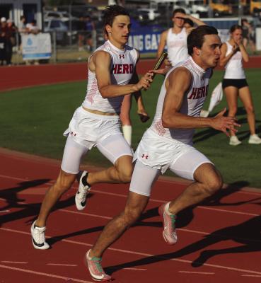 Holliday’s Hudson Dray hands off the baton to senior Ty Harrison in the 4x100 relay at the City View Heath Aldritch Relays on Wednesday, March 25. Photo/Landon Davis
