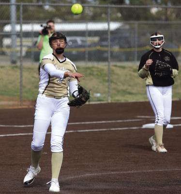 Archer City pitcher Addi Canada tosses the ball to first for an easy out during the Lady Cats game against Burkburnett in the Graham tournament. Photo/Landon Davis