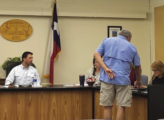 Archer City Councilman Billy Burks presents the planned improvements to the Archer County Shooting Sports Complex with Archer City 4B funds to fellow councilmembers on Aug. 30. Photo/Nathan Lawson