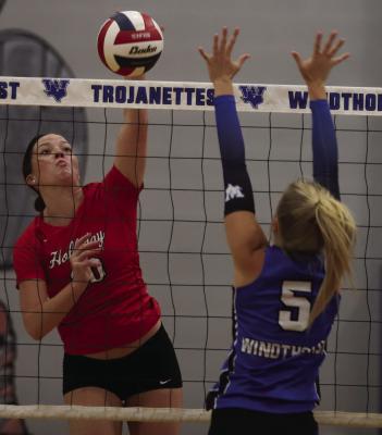 Holliday's Caitlyn Leggett looks to get a kill attempt past Windthorst's Jaylee Belcher in the Lady Eagles 3-1 win over the Trojanettes on Tuesday, Sept. 15. Photo/Rolando Medina