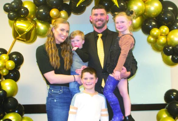 Bradan Ritchie (middle) poses for a photo with his wife, Kayla,and children Knox, Campbell and Whit after being named the ACISD athletic director and football coach in a Feburary board meeting. Ritchey would finish his first season as coach with a 7-4 record. File photo