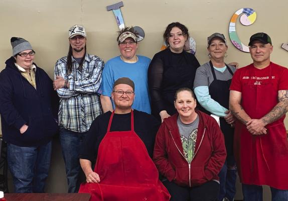 Gino and Stacy Rangel (seated center) are helping lead Lucky's Cafe in Archer City into a new era. The couple are bringing a new Tex-Mex centric menu to the resturant with the help of their staff (behind.) Photo/Nathan Lawson