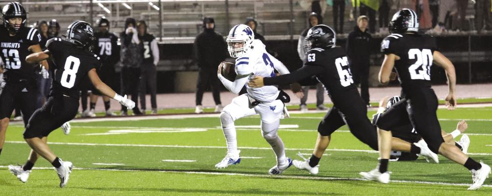 Depsite being surronded by five Knights, Windthorst's Brock Belcher powered through for a 44-yard touchdown run in the third quarter of the Trojans' 55-21 win over Lindsay in Bowie Thursday, Nov. 9. Photo/Nathan Lawson
