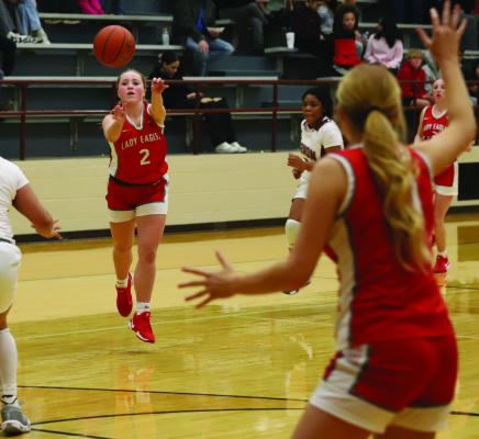 Lady Eagle guard Braylie Womack darts a pass inside to post Jordan Peters in Holliday’s 59-34 road victory over the Vernon Lady Lions. Photo/Landon Davis