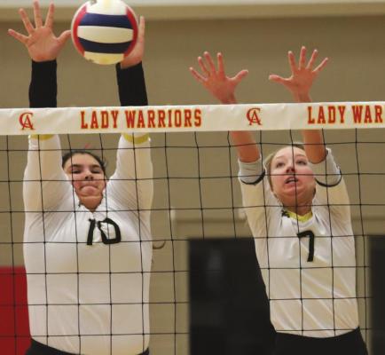 Archer City seniors Bailey Grant and Chandler Clark go up for a block in the second set of the Lady Cats’ 3-1 win over Christ Academy on Saturday, Sept. 11. Photo/Will Edwards