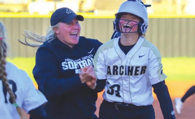 Archer City head coach Mallory Mooney celebrates with Vivian Rater following Rater’s walk-off single to lift the Lady Cats to a 10-9 win over Petrolia on Wednesday, March 30. Photo/Will Edwards