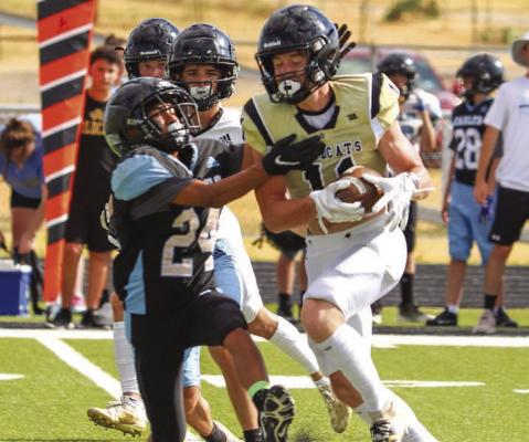 Archer City’s Noah Cornell fights for extra yardage after making a catch in the Wildcats’ scrimmage against TLCA on Thursday, Aug. 18. Photo/Will Edwards