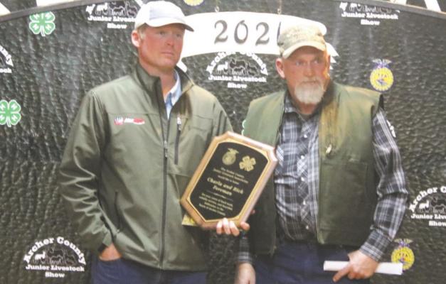 James Mitchell (left) presents a plaque to Rick Foreman for him and his late wife, Charla, for their service to the ACJLS. Photo/Jerry Phillips