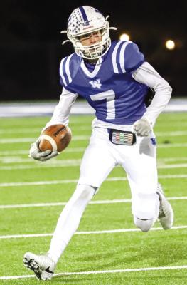 Kolby Teakell makes a cut during his 82-yard punt return for a touchdown in the first quarter of the Trojans 49-14 mauling of Electra on Friday, Nov. 4. Photo/Will Edwards