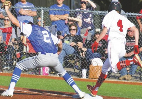 Kyle Wolf makes a great stretch at first base to get the Muenster runner by a step in the Trojans’ 1-0 win over the Hornets on Thursday, May 20, in Henrietta. The Trojans advanced to the regional semifinals where they meet Bosqueville later this week. Photo/Will Edwards
