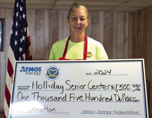 Pam Hughes Pak presented an Atmos Energy donation of $1,500 to the Holliday Meals on Wheels program in Holliday. Each daily meal is homemade, delicious, and focused on the needs of senior citizens in the City of Holliday. Pictured is Holliday Service Center Director Amanda Brown with the check. Courtesy photo