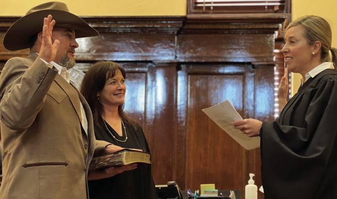New Archer County Commissioner Pct. 3 Kendall Coleman is sworn into office by 97th District Judge Trish Coleman Byars at the Archer County Courthouse on New Year's Day. Courtesy photo