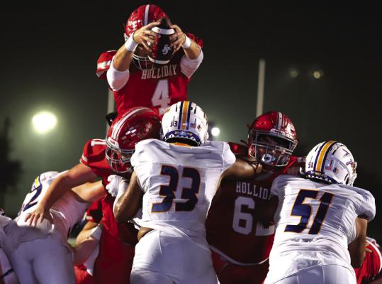 Holliday's Grant Cox rises above the offensive and defensive line for a touchdown during the Eagles 42-6 area round win over Leonard Friday, Nov. 17, in Weatherford Photo/Nathan Lawson
