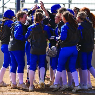 The Trojanettes mob senior Tara Tackett at home plate following a home run in Windthorst’s 12-0 win over Electra. File photo