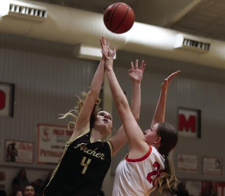 Archer City’s Lyla Nichols fights through contact for a layup over a Petrolia defender on Tuesday, Feb. 10. Photo/Landon Davis