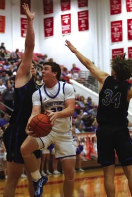 Windthorst’s Brock Belcher fights through contact for a layup in the Area-round clash with Lipan on Friday, Feb. 27. Photo/Landon Davis